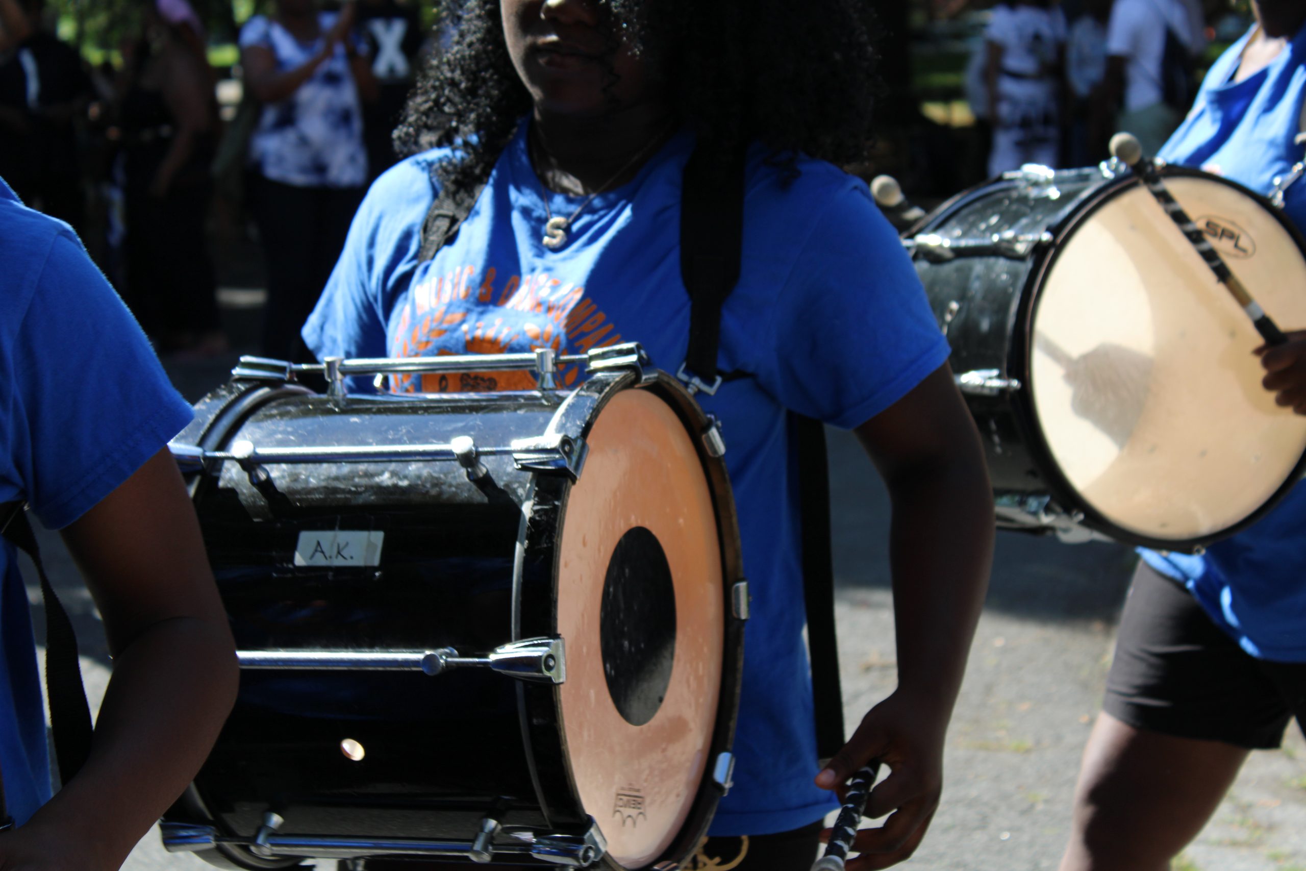 Drummers in blue shirts performing at the rally